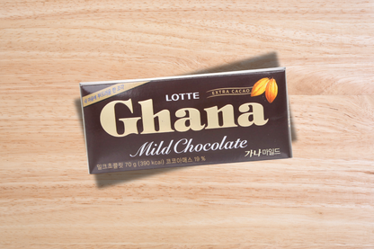 Lotte Ghana Mild Chocolate bar on a wooden surface