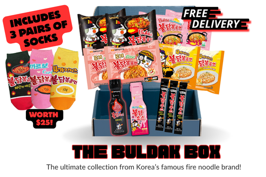 Buldak box with fire noodle packages and socks on a white background